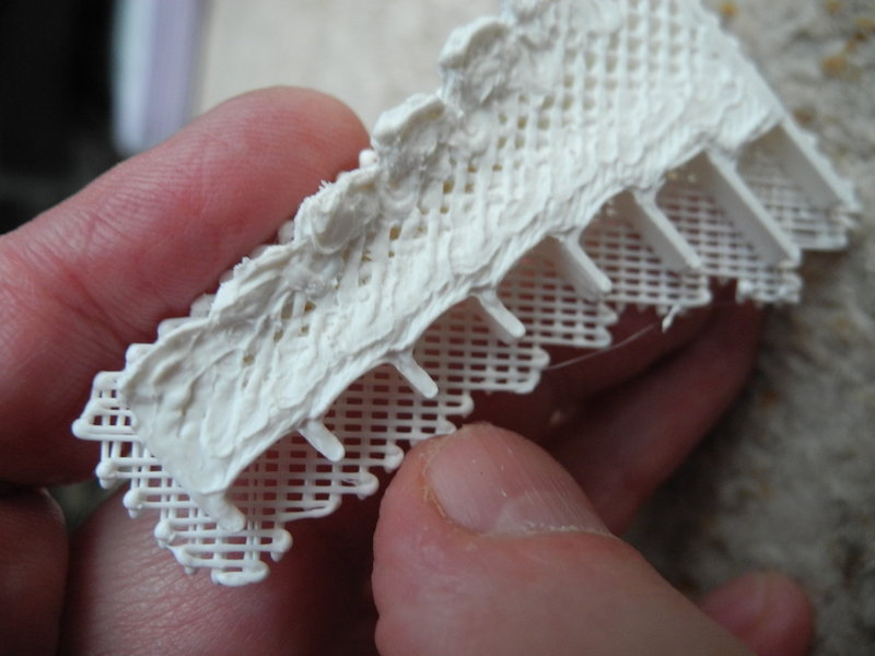 The overhangs warp upwards during printing.