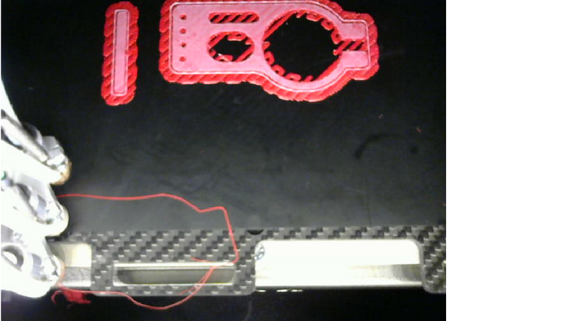 Here you see the grid and the interface deposited perfectly, while the material of the first layer of the objects don't deposit and, instead, they stay attached to the extruder tip.